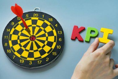 Renkli ahşap alfabe KPI dart tahtası ile tutarak el 
