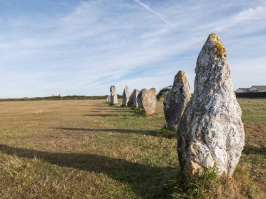 Alignment of megaliths on broad grass. clipart