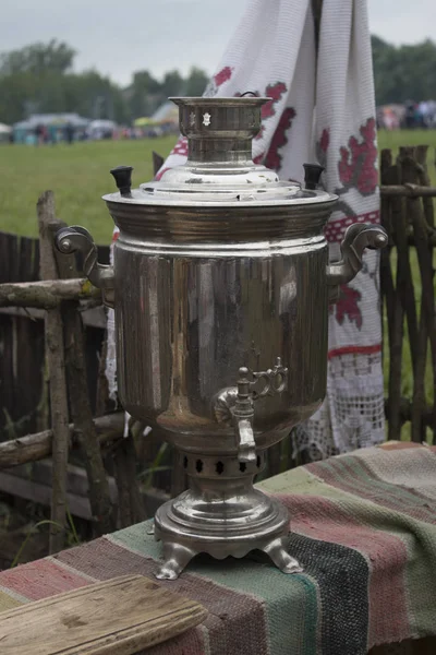 Vintage Russian samovar and bread salt on the table covered with a tablecloth.Welcome to Russia. From Russia with love.