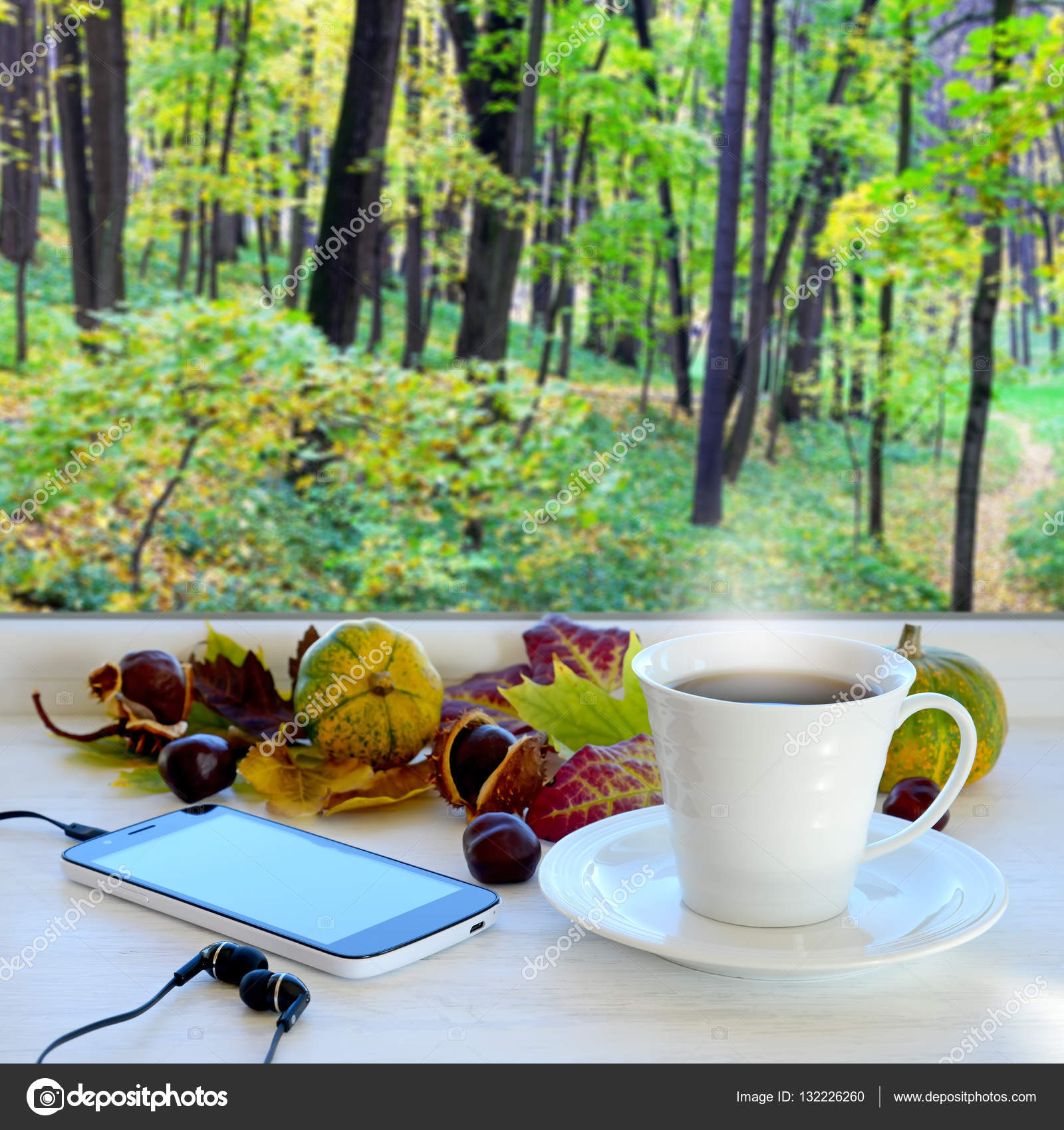 Cup of coffee, smartphone and headphones, autumn leaves, pumpkins ...