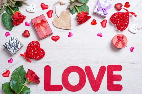 Wooden white background with red hearts, gifts and roses. The concept of Valentine Day — Stock Photo, Image