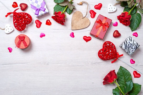 Wooden white background with red hearts, gifts and roses. The concept of Valentine Day — Stock Photo, Image