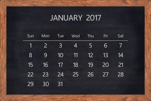 Enero mes 2017 calendario en marco de madera de pizarra . —  Fotos de Stock