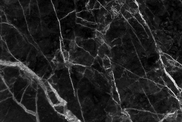 Black marble texture shot through with subtle white veining (Natural pattern for backdrop or background, Can also be used for create surface effect to architectural slab, ceramic floor and wall tiles)