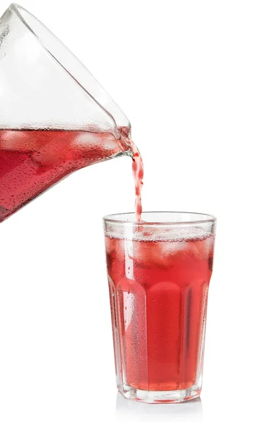 The drink poured into a glass on white background — Stock Photo, Image