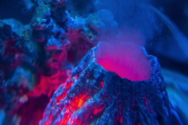 brightly illuminated artificial underwater volcano clipart