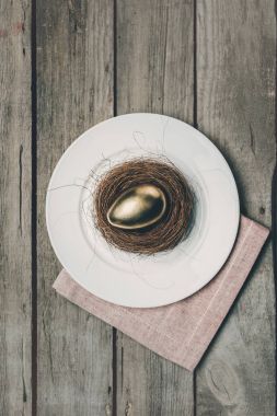 Golden Easter egg on plate  clipart