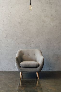 Grey armchair in empty room  clipart