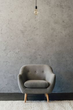 Grey armchair in empty room 