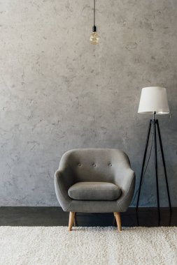 Grey armchair in empty room 