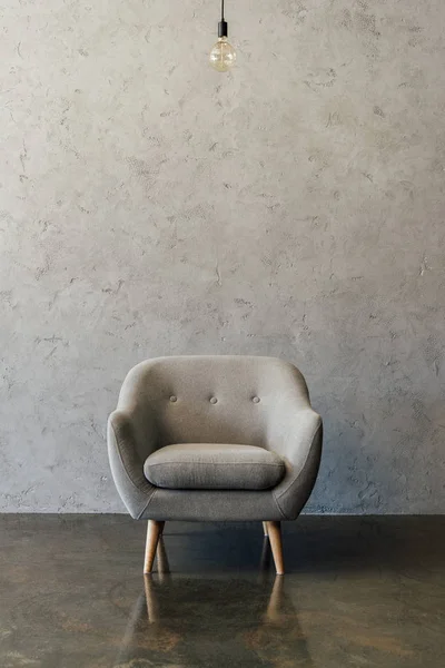 Grey armchair in empty room — Stock Photo, Image