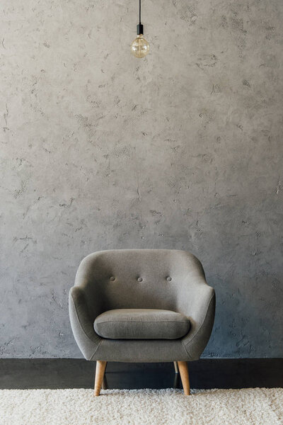 Grey armchair in empty room 