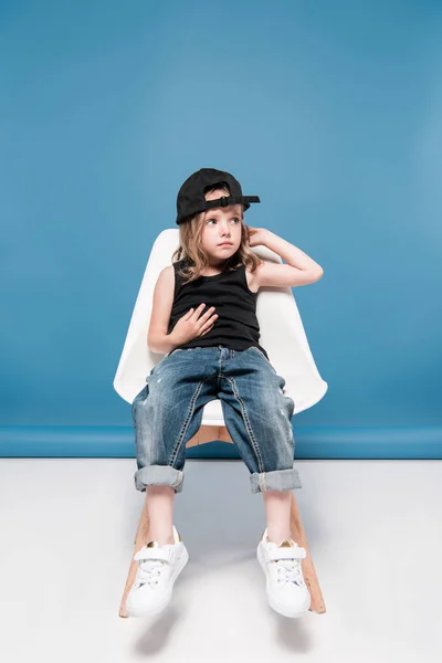 Stylish kid girl sitting on chair — Stock Photo, Image