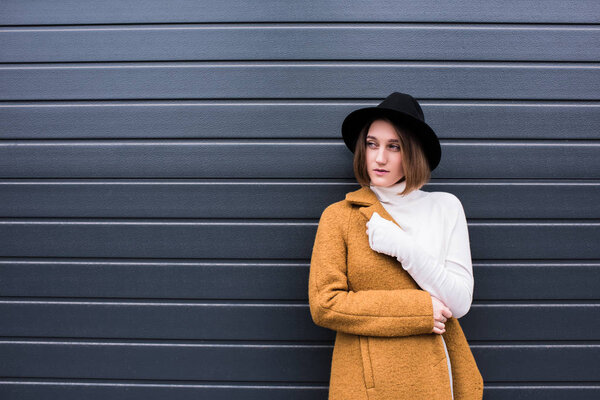 stylish woman in jacket and black hat