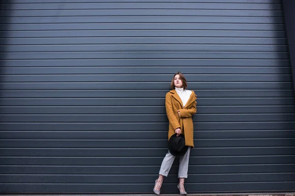 Stylish woman in jacket and black hat — Stock Photo, Image