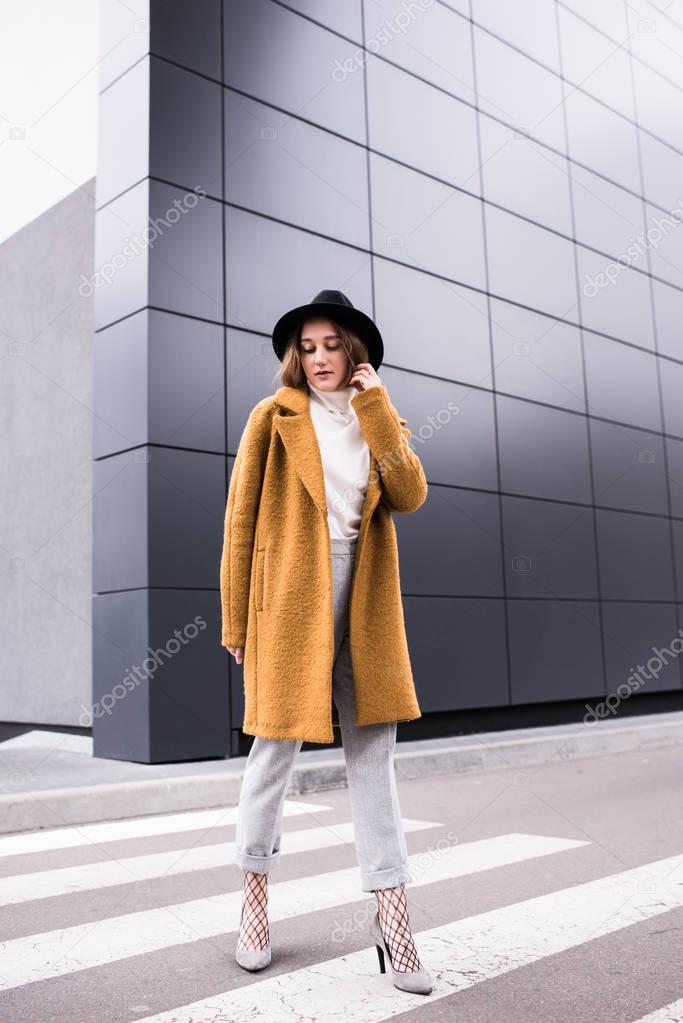 stylish woman in jacket and black hat