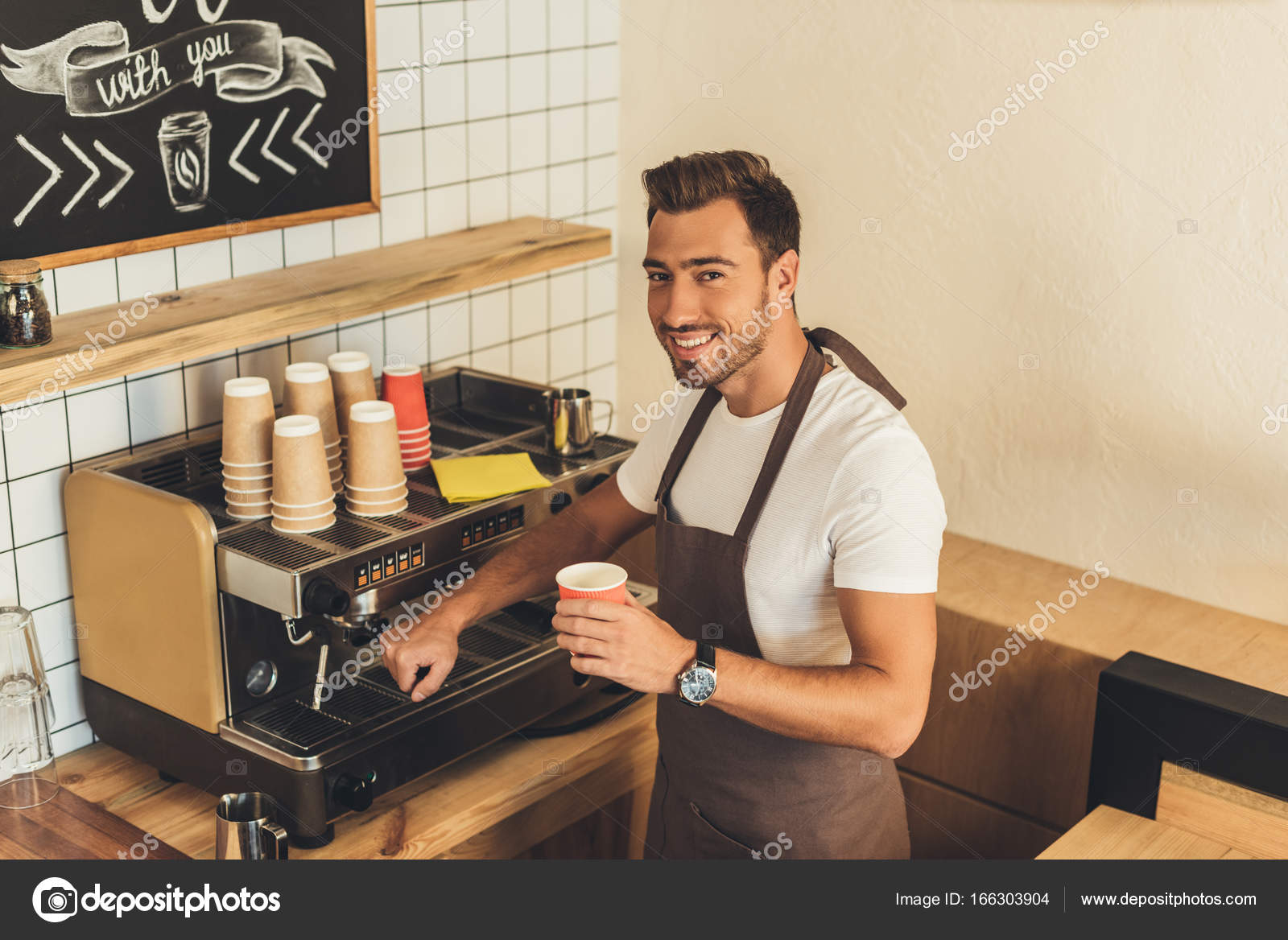 Smiling barista with coffee to go — Free Stock Photo © YBoychenko