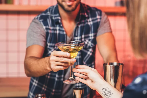 Barmann som gir cocktail til besøkende – stockfoto