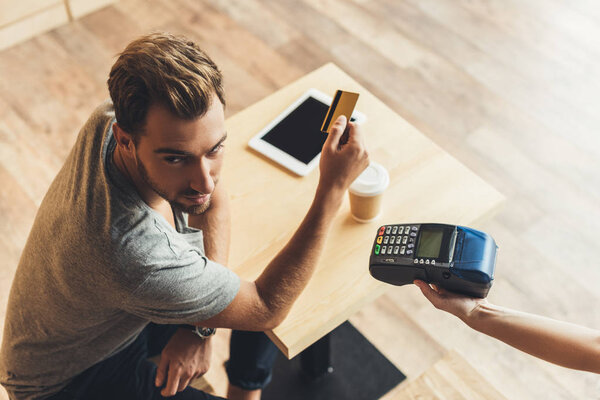 man paying with credit card