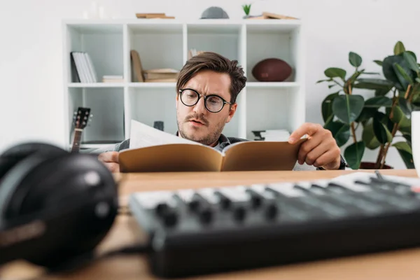 Young musician reading magazine — Stock Photo, Image