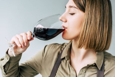 Female sommelier tasting red wine  clipart