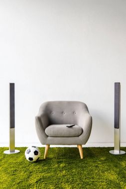 Armchair with remote controller, ball and loudspeakers  clipart