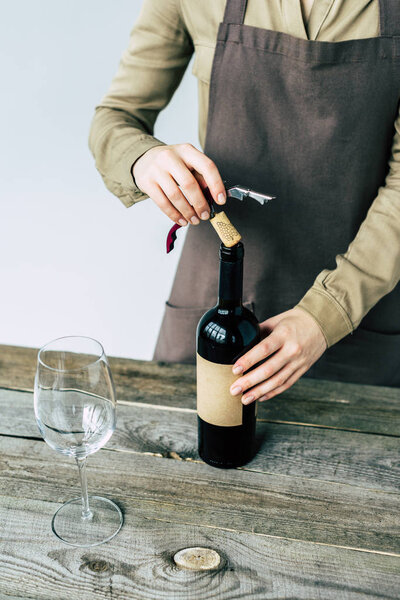 Sommelier opening bottle of red wine 