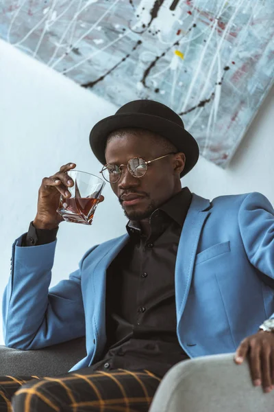 Confident african american man with cognac — Stock Photo, Image