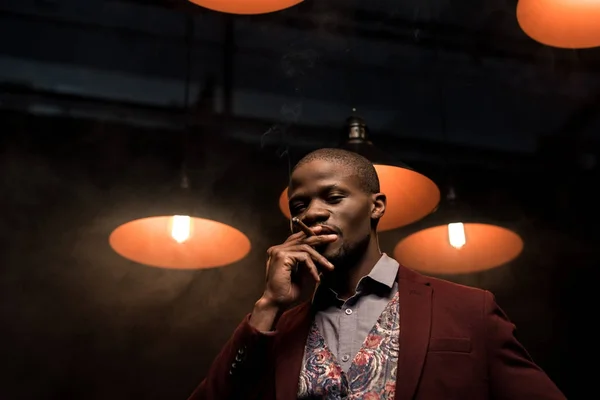 Handsome african american man with cigar — Free Stock Photo