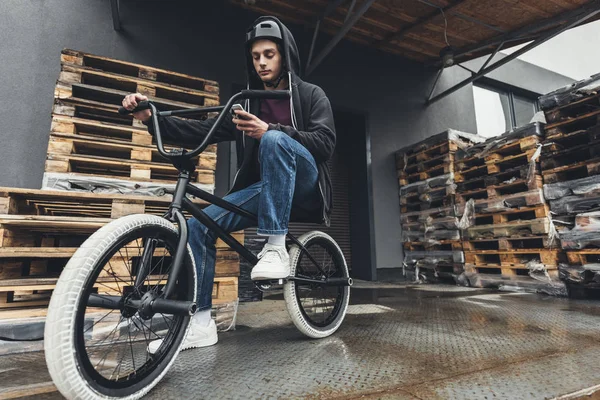 Biker BMX za pomocą smartfona — Zdjęcie stockowe