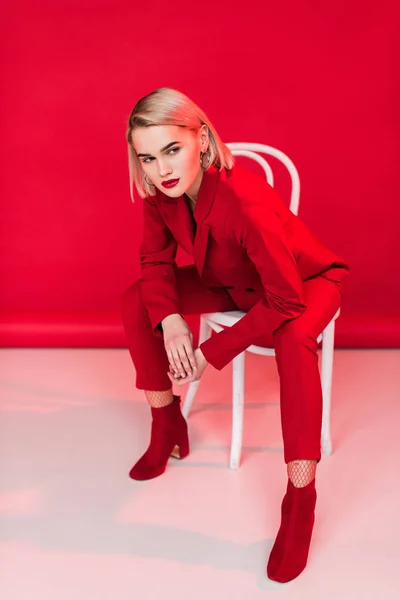 Fashionable girl posing in red suit — Stock Photo, Image