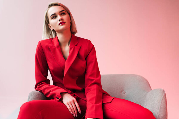 elegant woman posing in red clothes