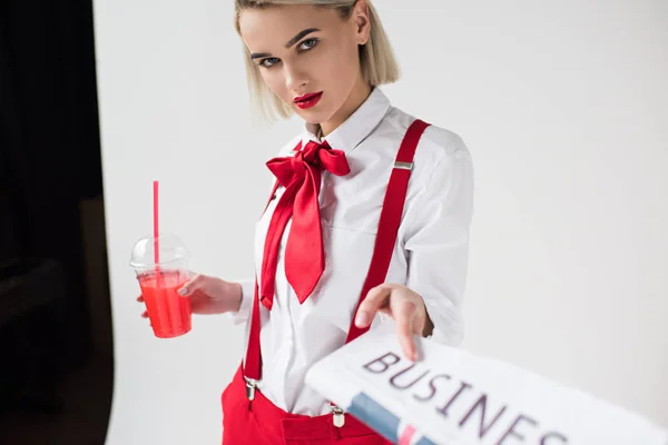 Fashionable girl with business newspaper and drink — Stock Photo, Image