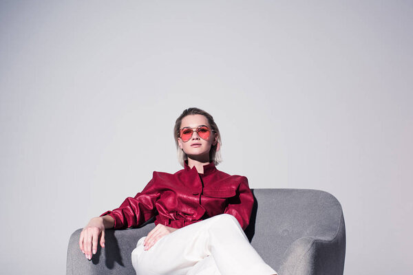 stylish girl posing in armchair