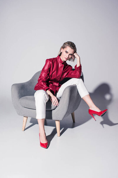 girl posing on armchair for fashion shoot