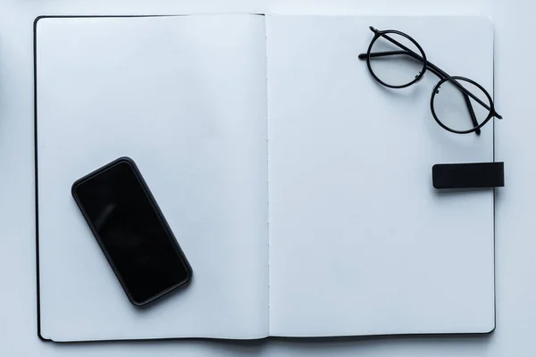 Top View Smartphone Glasses Open Notebook — Stock Photo, Image