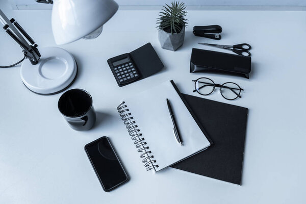 overhead view of notebook and pen on working table