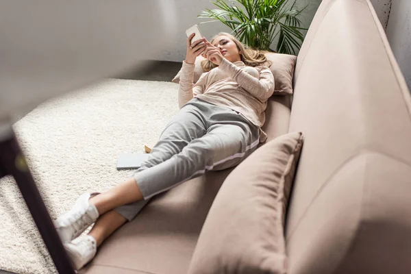 Stylische Junge Frau Mit Smartphone Auf Gemütlicher Couch Hause — Stockfoto