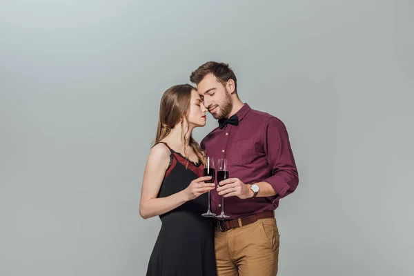 Belo Par Jovem Moda Segurando Copos Vinho Tinto Isolado Cinza — Fotografia de Stock