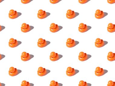 seamless pattern of cute orange rubber ducks with shadows on white  clipart