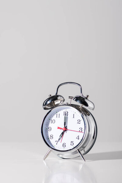close-up view of shiny alarm clock on grey