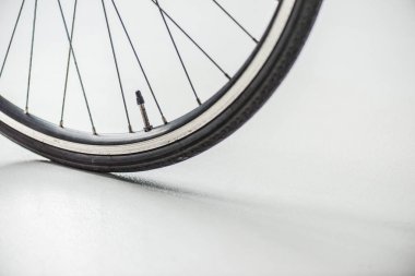 bicycle wheel with rim, tire and spokes with valve on white clipart