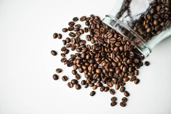 Bovenaanzicht Van Verspreide Koffiebonen Uit Glazen Fles Geïsoleerd Wit — Stockfoto