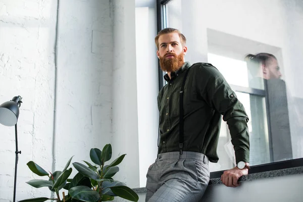 Handsome Bearded Businessman Leaning Windowsill Looking Away — Free Stock Photo