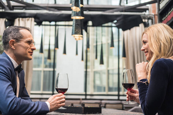 side view of adult couple drinking wine at restaurant