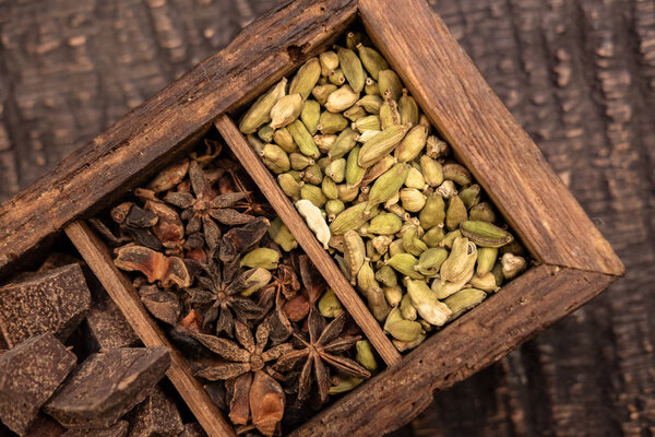 top view of wooden box with various spices on table