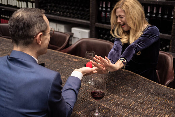 screaming woman refusing propose from her boyfriend at restaurant