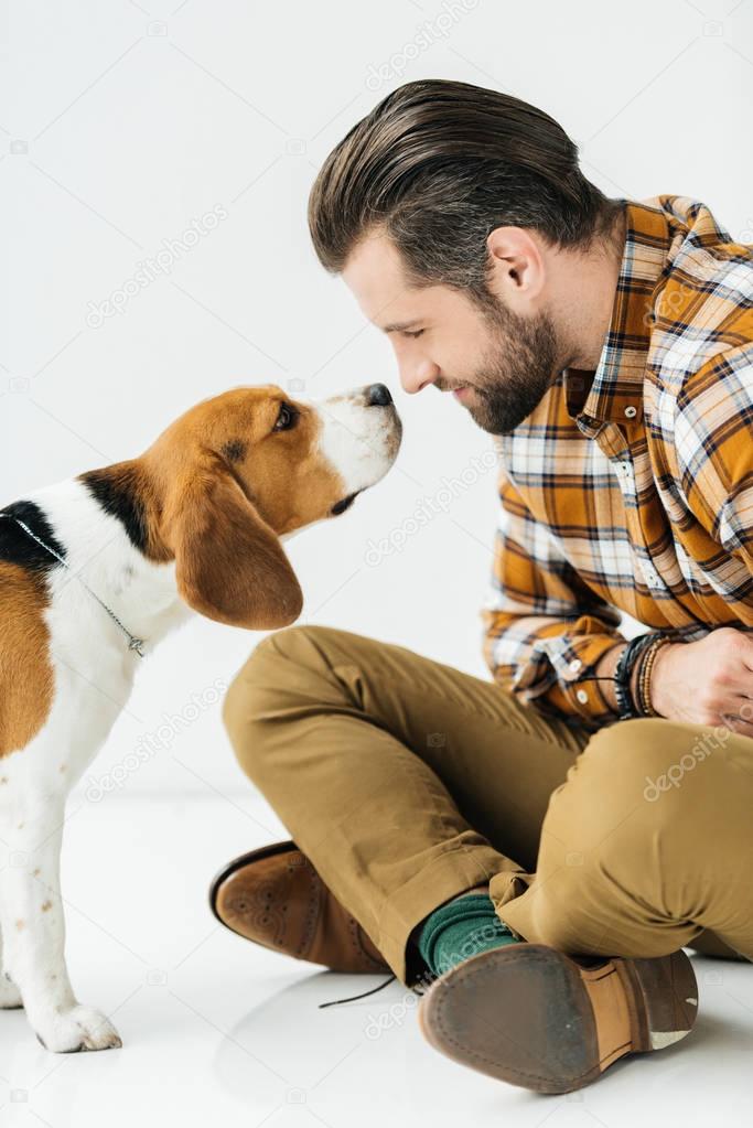 side view of dog sniffing man nose