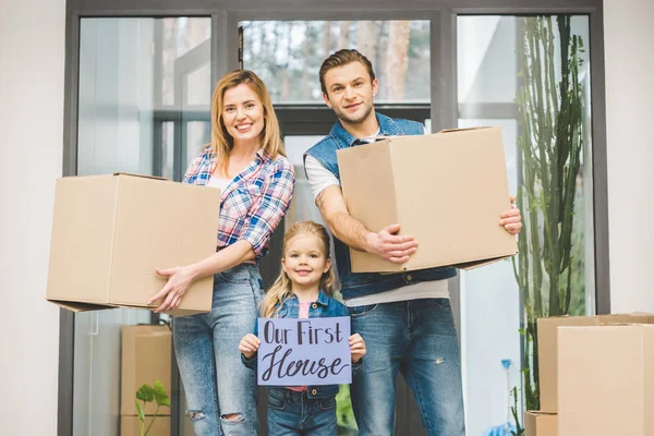 Portrait Smiling Parents Daughter Our New House Board Hands Moving — Stock Photo, Image