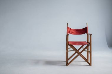 red chair on grey with copy space clipart